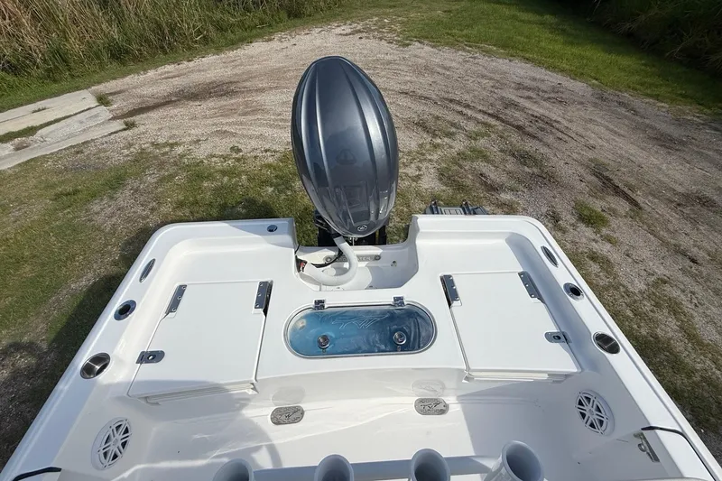 Slide: The Image of 2026 Tidewater 2110 Bay Max boat with outboard motor and storage compartments. - 23