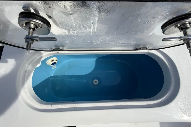 Slide: The Image of Livewell of 2026 Tidewater 2110 Bay Max boat, featuring a blue interior. - 26