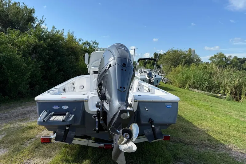 Slide: The Image of 2026 Tidewater 2110 Bay Max boat with outboard motor on grassy area. - 3