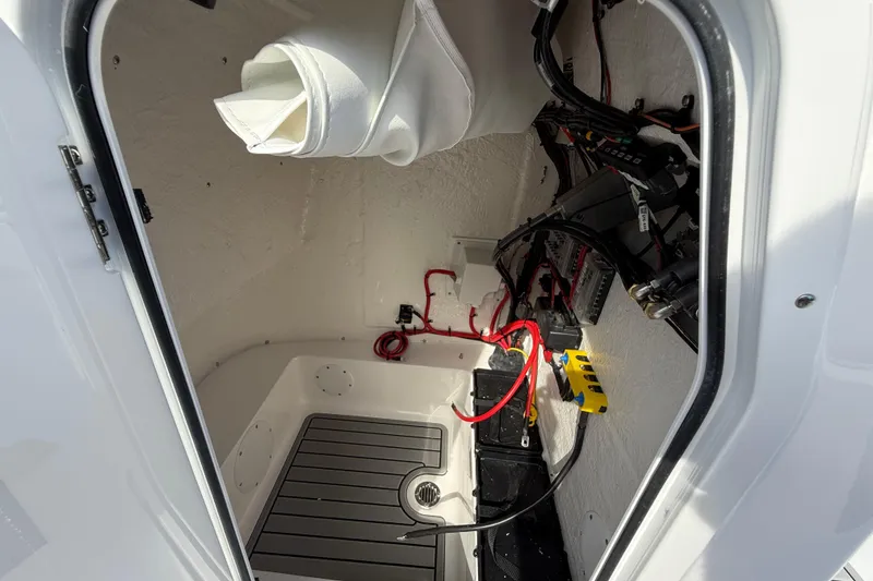 Slide: The Image of Interior view of 2026 Tidewater 2110 Bay Max boat showing wiring and storage compartment. - 30