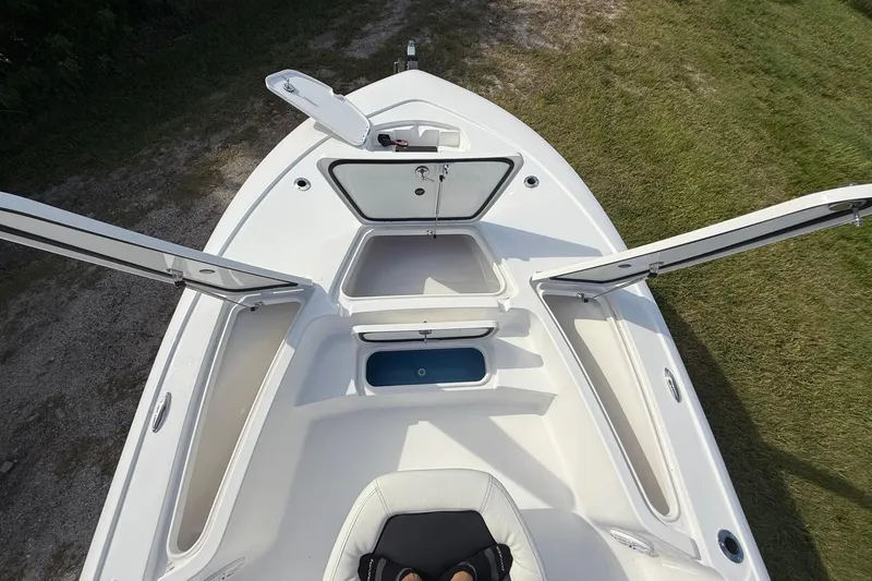 Slide: The Image of 2026 Tidewater 2110 Bay Max boat with open storage compartments, viewed from above. - 31