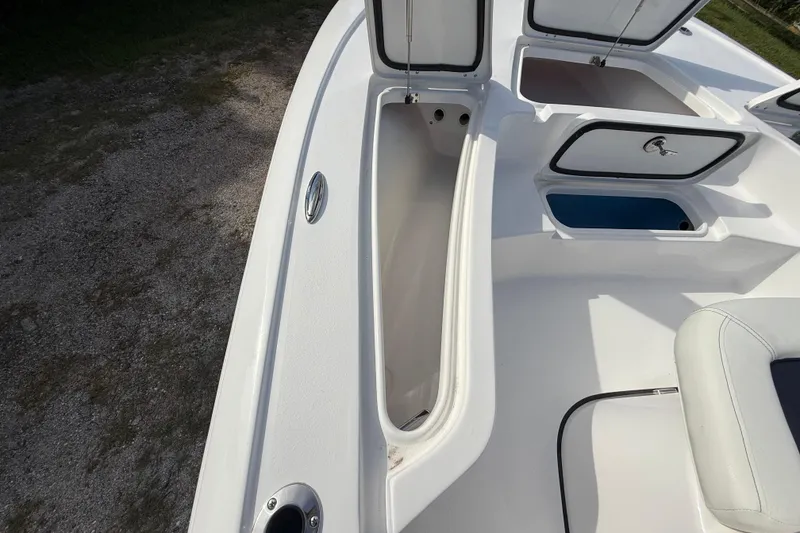 Slide: The Image of 2026 Tidewater 2110 Bay Max boat with open storage compartments and seating area. - 32
