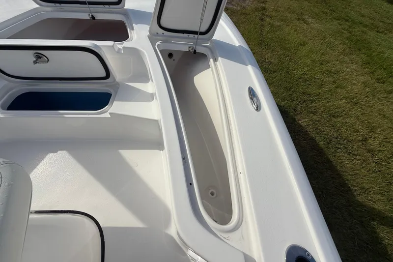 Slide: The Image of 2026 Tidewater 2110 Bay Max boat storage compartments, open on deck, showcasing spacious design. - 34