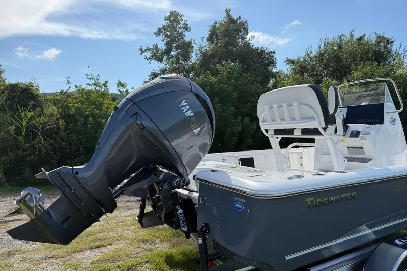 Slide: The Image of 2026 Tidewater 2110 Bay Max boat with Yamaha outboard motor, parked outdoors. - 6