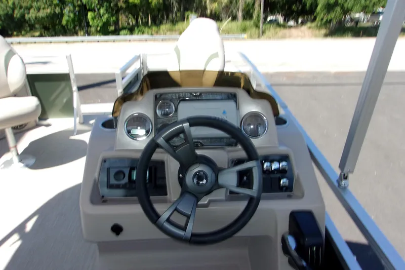 Slide: The Image of 2023 Tahoe Pontoon 1775 Sport Bow dashboard with steering wheel and controls. - 5