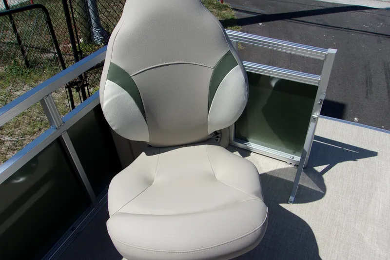 Slide: The Image of 2023 Tahoe Pontoon 1775 Sport Bow seat, beige and green, on deck. - 7