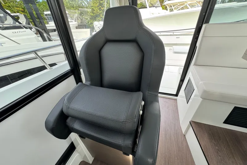 Slide: The Image of 2026 Jeanneau NC 895 Sport Series 2 cabin interior with control panels and seating. - 12