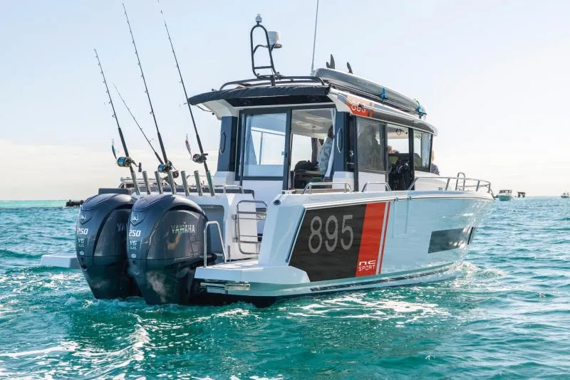 Slide: The Image of 2026 Jeanneau NC 895 Sport Series 2 boat docked at marina with Yamaha engines. - 2