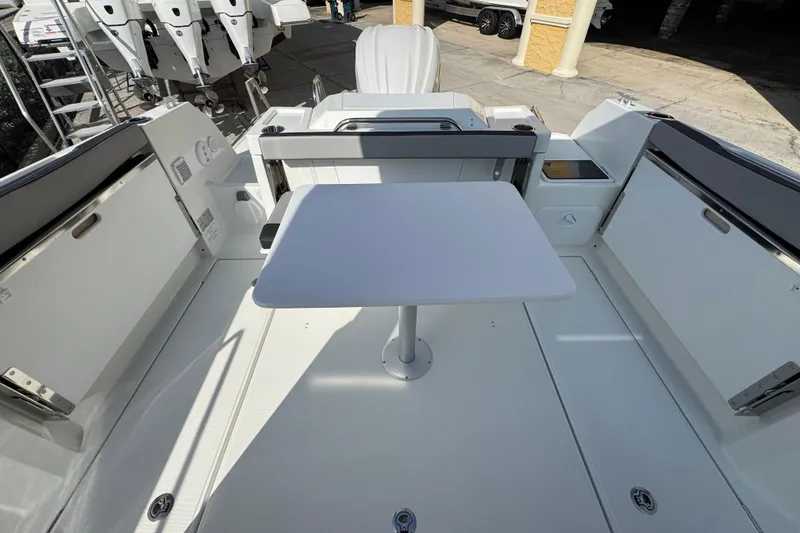 Slide: The Image of 2026 Jeanneau NC Sport 795 Series 2 boat deck with table and seating area. - 6