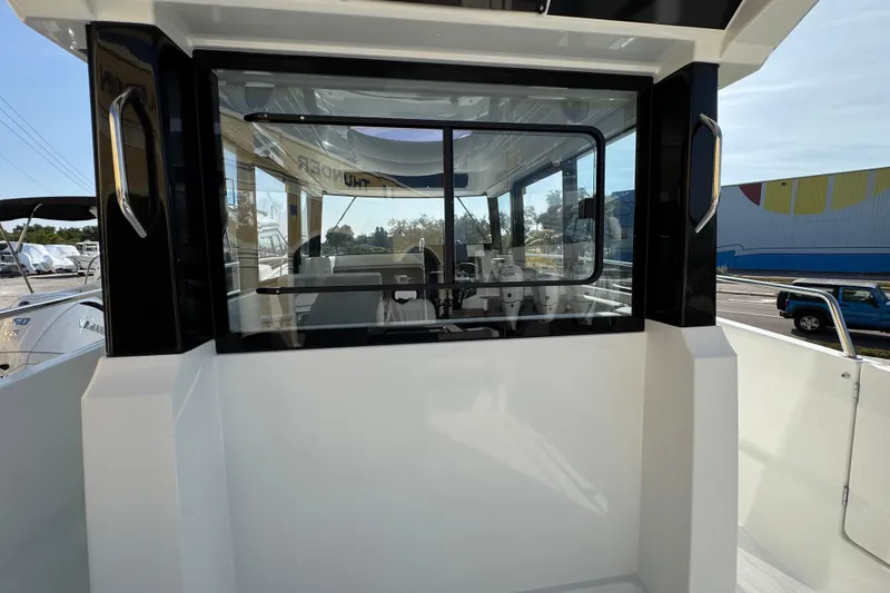 Slide: The Image of 2026 Jeanneau NC Sport 795 Series 2 boat exterior with sleek design and large windows. - 9