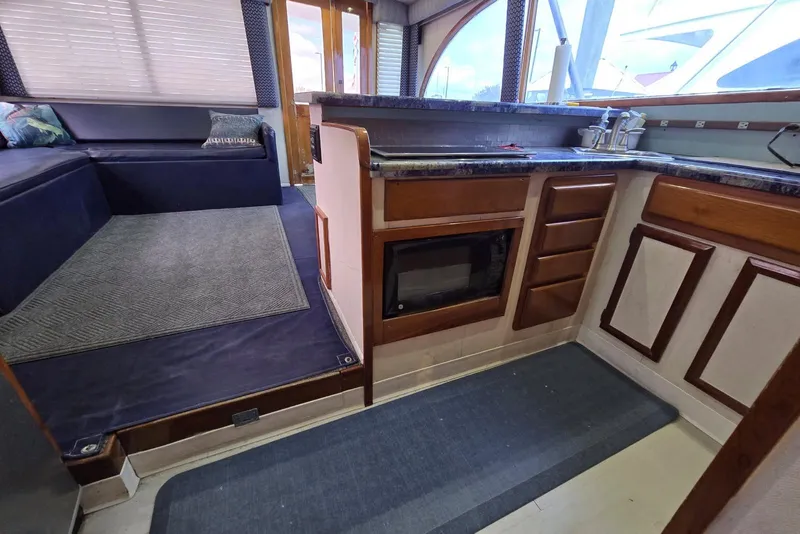 Slide: The Image of Interior of 1988 Topaz 44 Flybridge yacht with kitchen and seating area. - 10