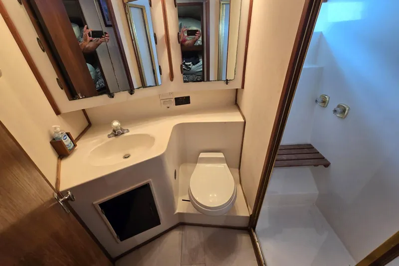 Slide: The Image of Compact bathroom in 1988 Topaz 44 Flybridge yacht with sink, toilet, and shower. - 12