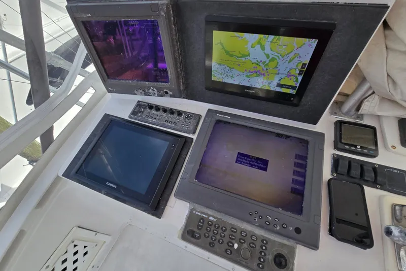 Slide: The Image of Control panel of a 1988 Topaz 44 Flybridge with navigation screens and instruments. - 20