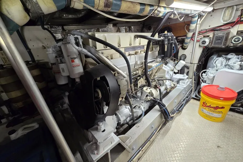 Slide: The Image of Engine room of a 1988 Topaz 44 Flybridge boat, featuring detailed machinery and components. - 24