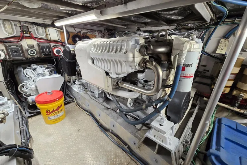 Slide: The Image of Engine room of a 1988 Topaz 44 Flybridge boat, showcasing machinery and equipment. - 25