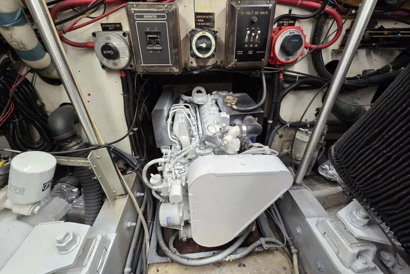 Slide: The Image of Engine room of 1988 Topaz 44 Flybridge with generator and wiring components. - 26