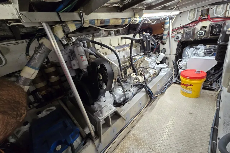 Slide: The Image of Engine room of a 1988 Topaz 44 Flybridge boat, featuring mechanical components and equipment. - 30