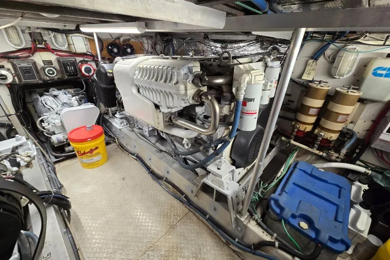 Slide: The Image of Engine room of a 1988 Topaz 44 Flybridge boat, showcasing machinery and equipment. - 31