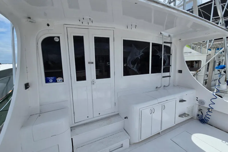Slide: The Image of 1988 Topaz 44 Flybridge boat interior with white cabinetry and marlin window design. - 35