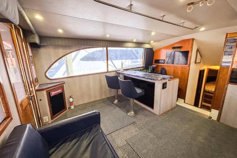 Slide: The Image of Interior of 1988 Topaz 44 Flybridge yacht with modern seating and entertainment area. - 37