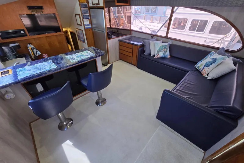 Slide: The Image of Interior of 1988 Topaz 44 Flybridge yacht with modern seating and large windows. - 42
