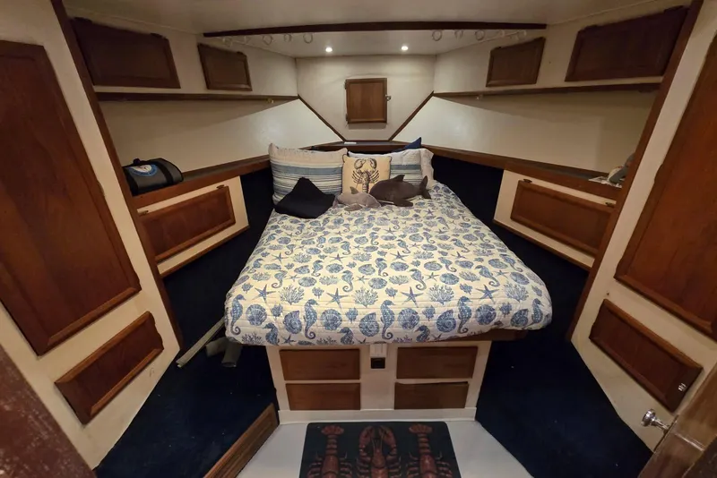 Slide: The Image of Cozy cabin interior of 1988 Topaz 44 Flybridge with nautical-themed bedding and wooden accents. - 7