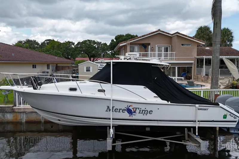 The Image of 2007 Pursuit OS 335 Offshore boat on trailer under blue sky. - 0