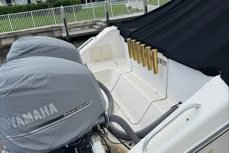 Slide: The Image of 2007 Pursuit OS 335 Offshore boat docked in a serene canal setting. - 10