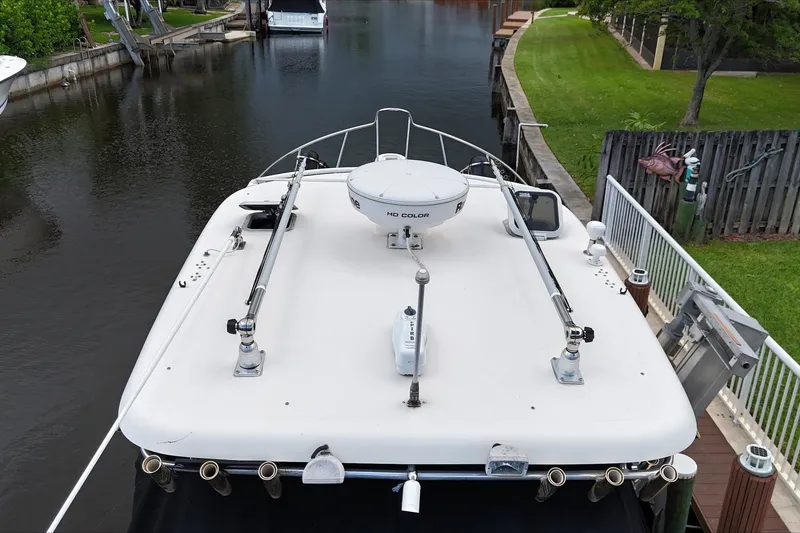 Slide: The Image of 2007 Pursuit OS 335 Offshore boat with Yamaha engines docked by a canal. - 11