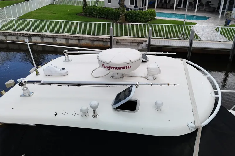 Slide: The Image of 2007 Pursuit 335 Offshore boat docked, showcasing windshield and deck features. - 12