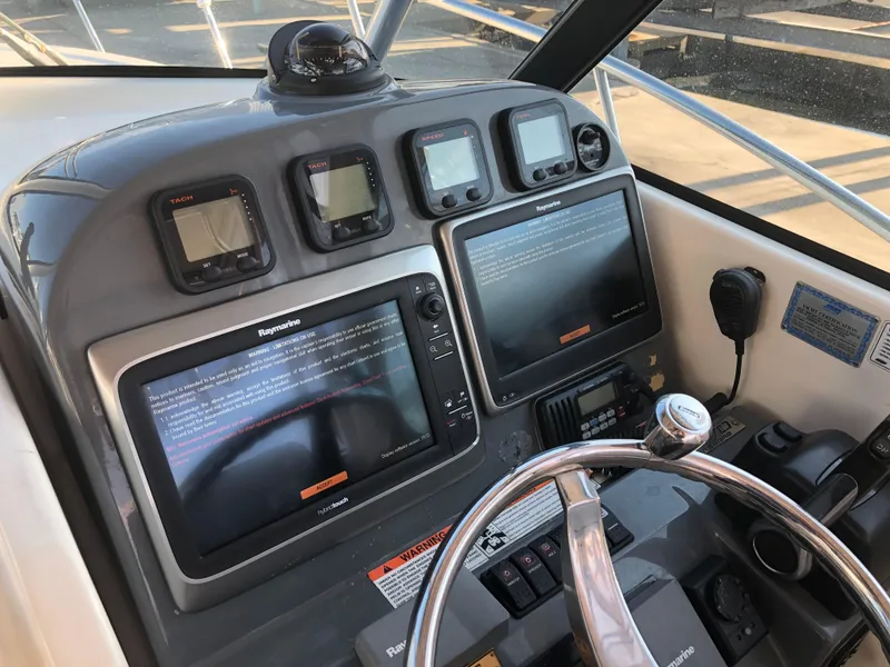 Slide: The Image of 2007 Pursuit OS 335 Offshore boat with Raymarine radar, docked near a poolside area. - 15