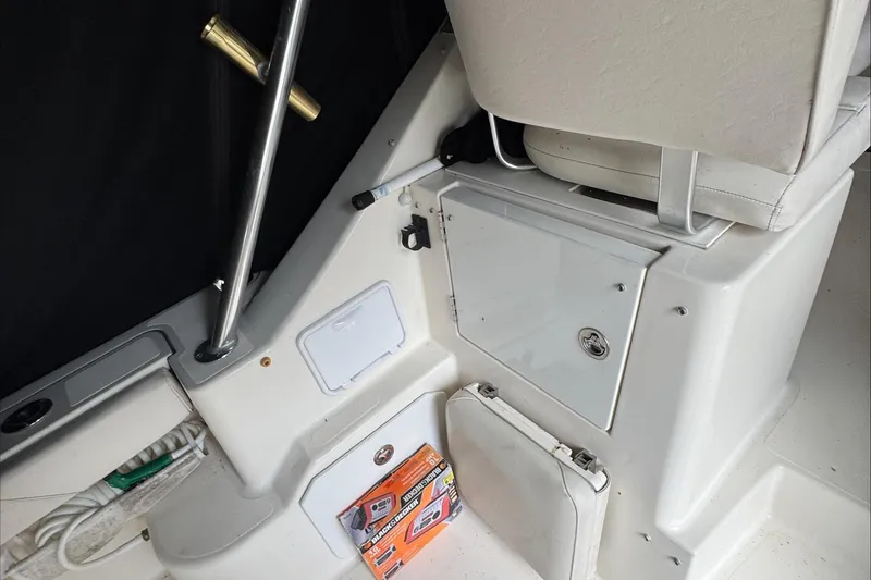 Slide: The Image of 2007 Pursuit OS 335 Offshore boat interior with helm, steering wheel, and seating. - 21