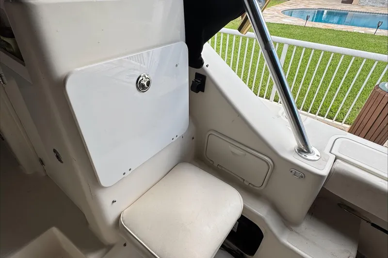 Slide: The Image of 2007 Pursuit OS 335 Offshore helm with steering wheel and captain's chair. - 22
