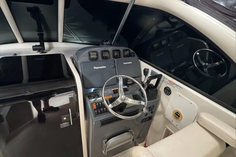 Slide: The Image of 2007 Pursuit OS 335 Offshore boat interior with storage compartments and seating. - 24