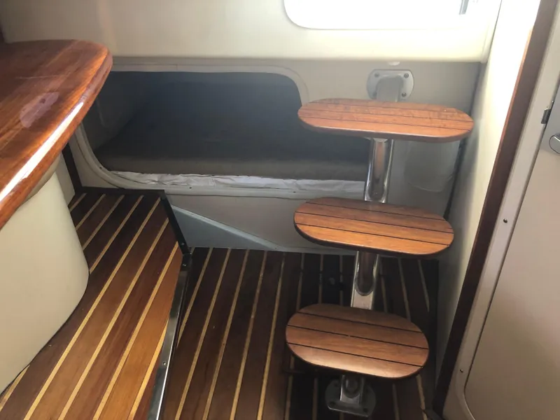 Slide: The Image of 2007 Pursuit OS 335 Offshore boat interior with seating and storage compartments. - 25