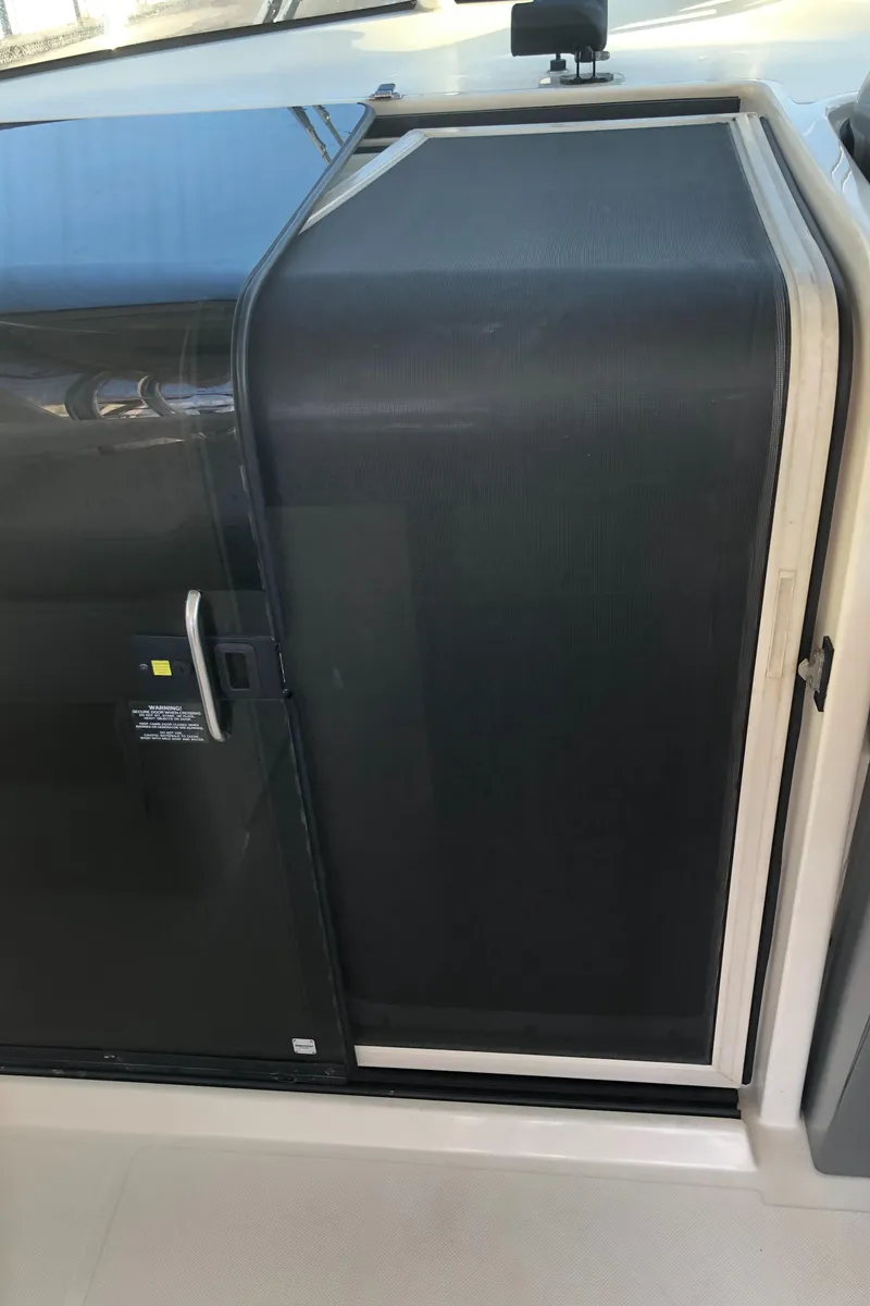 Slide: The Image of 2007 Pursuit 335 Offshore cabin with vintage TV and wooden cabinet. - 32