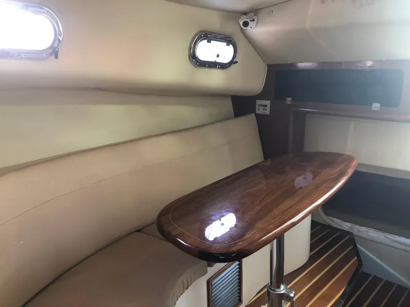 Slide: The Image of 2007 Pursuit 335 Offshore boat kitchen with sink, microwave, and wooden cabinets. - 34