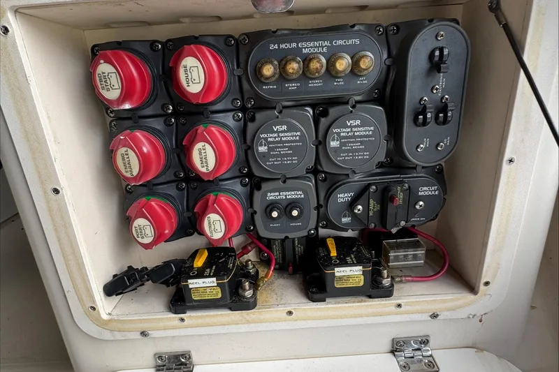 Slide: The Image of Electrical panel of a 2007 Pursuit OS 335 Offshore boat with circuit modules. - 40