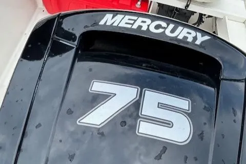 Slide: The Image of 2023 Boston Whaler 160 Super Sport boat on trailer, parked on a tree-lined street. - 10