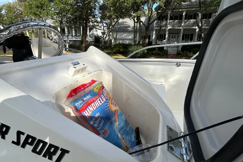 Slide: The Image of 2023 Boston Whaler 160 Super Sport boat storage compartment with handheld flare pack. - 13