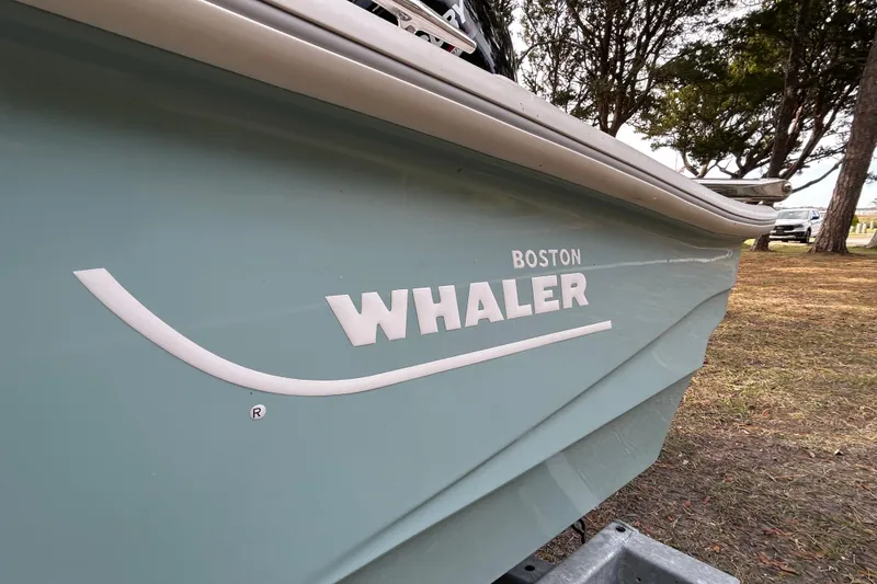 Slide: The Image of 2023 Boston Whaler 160 Super Sport boat on a trailer, parked outdoors. - 18