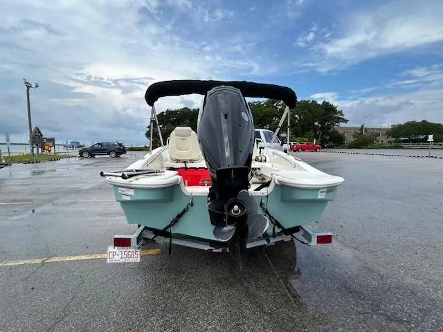 Slide: The Image of 2023 Boston Whaler 160 Super Sport boat parked near a scenic road. - 2