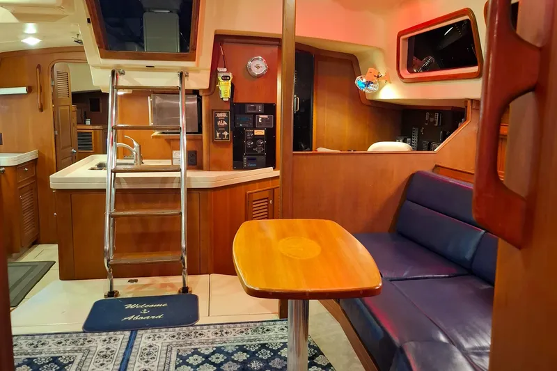 Slide: The Image of Interior of 2003 Island Packet 485 yacht with wooden furnishings and blue seating. - 12