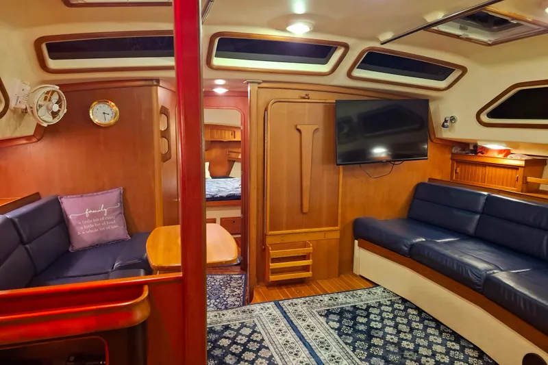 Slide: The Image of Luxurious interior of 2003 Island Packet 485 yacht with blue seating and wooden accents. - 15