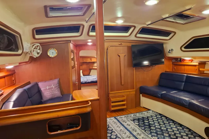 Slide: The Image of Luxurious interior of 2003 Island Packet 485 yacht with cozy seating and elegant wood finishes. - 18