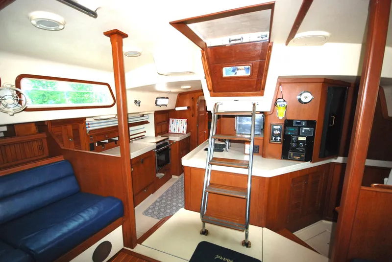 Slide: The Image of Interior of 2003 Island Packet 485 yacht with wooden cabinetry and blue seating. - 19