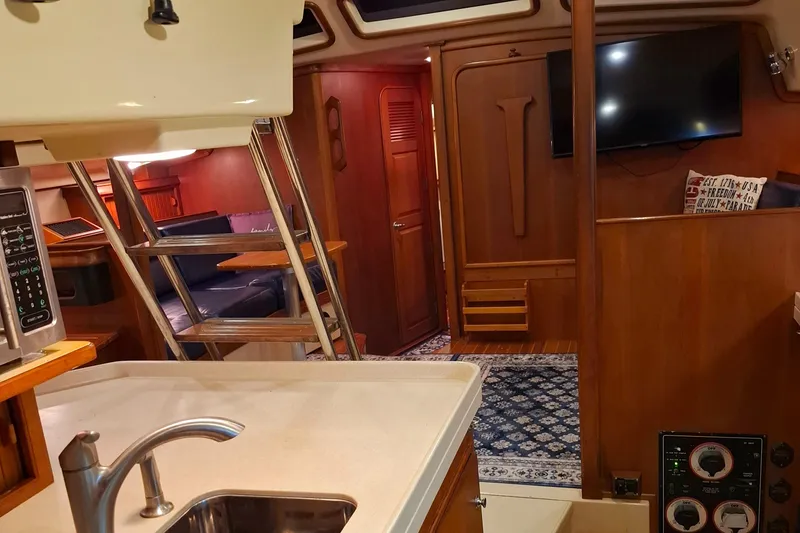 Slide: The Image of Interior of 2003 Island Packet 485 yacht with kitchen, seating, and TV. - 22