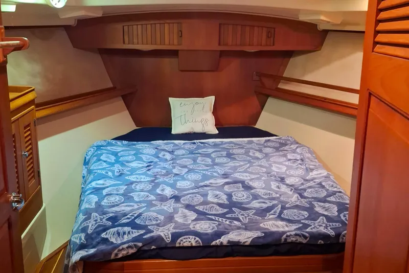 Slide: The Image of Cozy cabin interior of 2003 Island Packet 485 with nautical-themed bedding. - 23