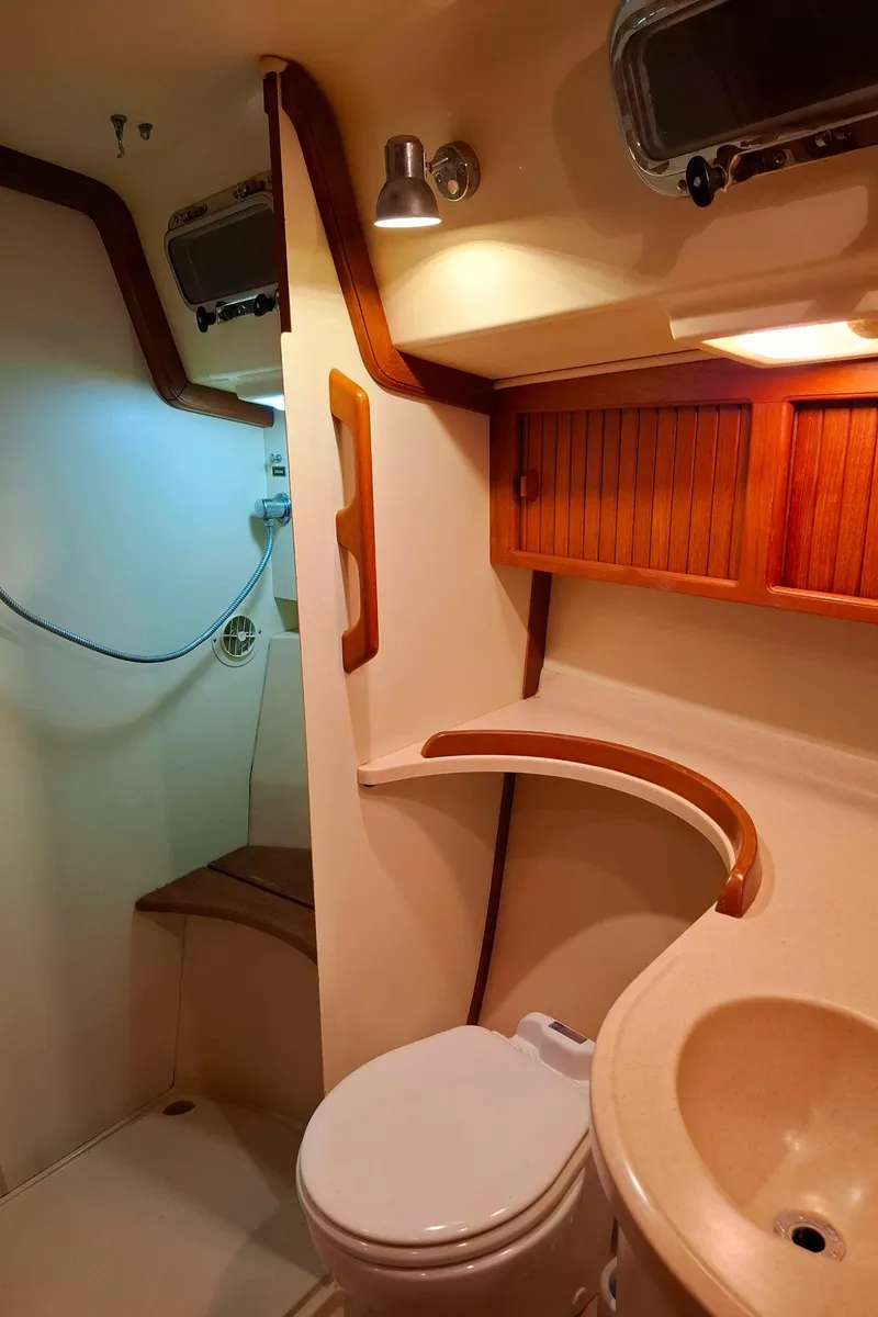 Slide: The Image of Luxurious bathroom in 2003 Island Packet 485 yacht with wooden accents and modern fixtures. - 26