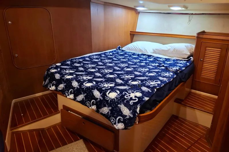 Slide: The Image of Cozy cabin interior of 2003 Island Packet 485 with nautical-themed bedding. - 28